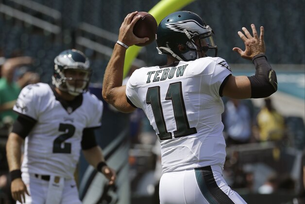 Philadelphia Eagles' Tim Tebow, right, and Matt Barkley warm up before a preseason NFL football game against the Indianapolis Colts, Sunday, Aug. 16, 2015, in Philadelphia. (AP Photo/Michael Perez)