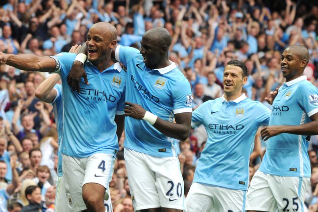 Manchester City’s Vincent Kompany, left, celebrates with teammates after scoring against Chelsea during the English Premier League soccer match between Manchester City and Chelsea at Etihad stadium, Manchester, England, Sunday, Aug. 16, 2015. (AP Photo/Rui Vieira)