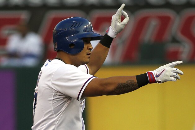 Texas Rangers right fielder Shin-Soo Choo  points to the Rangers dugout after hitting a double in the first inning of a baseball game against the Tampa Bay Rays Saturday, Aug. 15, 2015, in Arlington, Texas. The Rangers defeated the Rays 12-4. (AP Photo/Ron Jenkins)