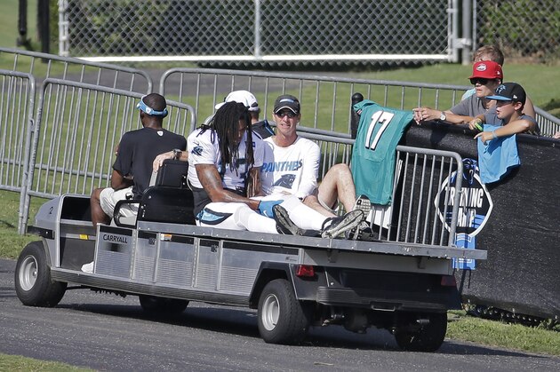 Carolina Panthers' Kelvin Benjamin (13) holds his left knee as he is carted off the field after being injured during a joint practice with the Miami Dolphins at NFL football training camp in Spartanburg, S.C., Wednesday, Aug. 19, 2015. (AP Photo/Chuck Burton)