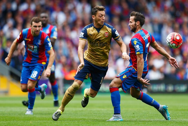 LONDON, ENGLAND - AUGUST 16: Mesut Oezil of Arsenal is challenged by Yohan Cabaye of Crystal Palace during the Barclays Premier League match between Crystal Palace and Arsenal at Selhurst Park on August 16, 2015 in London, England.  (Photo by Julian Finney/Getty Images)