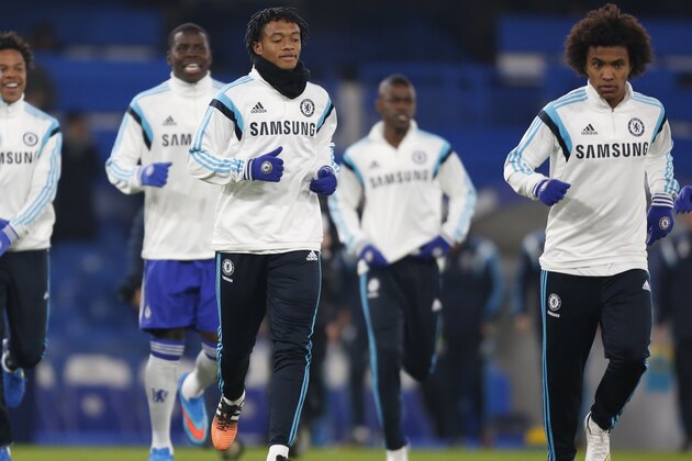 Chelsea's Colombian midfielder Juan Cuadrado (3rd R) and Chelsea's Brazilian midfielder Willian (R) warm up ahead of the English Premier League football match between Chelsea and Everton at Stamford Bridge in London on February 11, 2015. AFP PHOTO / IAN KINGTON

RESTRICTED TO EDITORIAL USE. NO USE WITH UNAUTHORIZED AUDIO, VIDEO, DATA, FIXTURE LISTS, CLUB/LEAGUE LOGOS OR 'LIVE' SERVICES. ONLINE IN-MATCH USE LIMITED TO 45 IMAGES, NO VIDEO EMULATION. NO USE IN BETTING, GAMES OR SINGLE CLUB/LEAGUE/PLAYER PUBLICATIONS.        (Photo credit should read IAN KINGTON/AFP/Getty Images)
