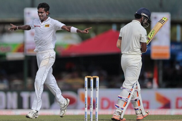 Sri Lanka's Dushmantha Chameera, left, celebrates the dismissal of India's Lokesh Rahul during the first day's play of their second test cricket match in Colombo, Sri Lanka, Thursday, Aug. 20, 2015. (AP Photo/Eranga Jayawardena)