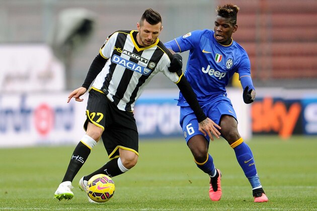 Udinese's forward Cyril Thereau vies with Juventus's midfielder Paul Labile Pogba (R) during the Italian Serie A football match between Udinese and Juventus on February 1, 2015 at Friuli Stadium in Udine.  AFP PHOTO / SIMONE FERRARO        (Photo credit should read SIMONE FERRARO/AFP/Getty Images)