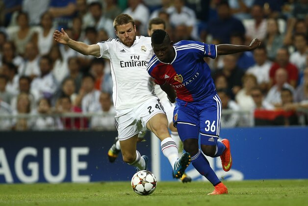Real's Asier Illarramendi and Basel's Breel Embolo challenge for the ball during the Champions League Group B soccer match between Real Madrid and Basel at the Santiago Bernabeu stadium in Madrid, Spain, Tuesday, Sept. 16, 2014. (AP Photo/Andres Kudacki)