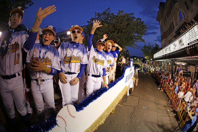 Members of the Little League team from Australia ride in the Little League Grand Slam Parade in downtown Williamsport, Pa., Wednesday, Aug. 19, 2015. The Little League World Series tournament gets started, Thursday, August 20, in South Williamsport, Pa.. AP Photo/Gene J. Puskar).