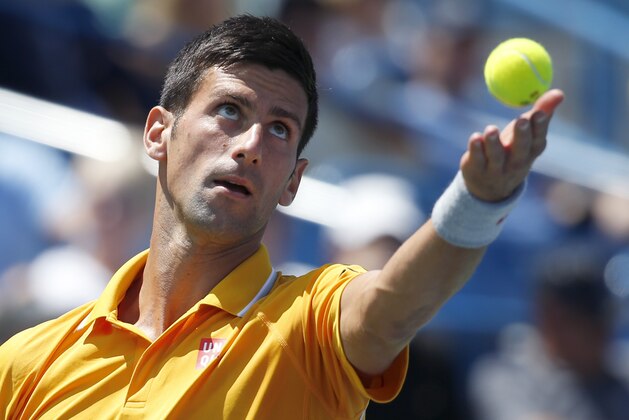 Novak Djokovic, of Serbia, serves to David Goffin, of Belgium, during a match at the Western & Southern Open tennis tournament, Thursday, Aug. 20, 2015, in Mason, Ohio. (AP Photo/John Minchillo)