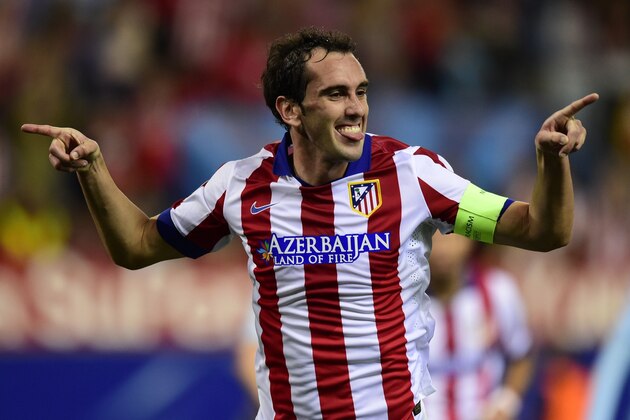 Atletico Madrid's Uruguayan defender Diego Godin celebrates after scoring their fourth goal during the UEFA Champions League football match Club Atletico de Madrid vs Malmo FF at the Vicente Calderon stadium in Madrid on October 22, 2014.   AFP PHOTO/ JAVIER SORIANO        (Photo credit should read JAVIER SORIANO/AFP/Getty Images)