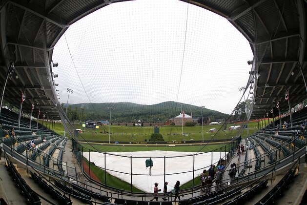 Rain falls on the covered field at Lamade Stadium Thursday, Aug. 20, 2015 in South Williamsport, Pa. The opening ceremony and the first day of four games of the Little League World Series tournament has been postponed due to rain. The tournament will resume play on Friday. (AP Photo/Gene J. Puskar)
