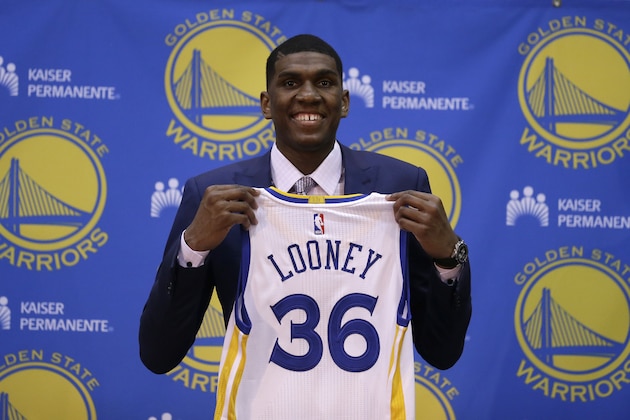 Golden State Warriors' Kevon Looney holds his new jersey during a media conference Friday, June 26, 2015, in Oakland, Calif. With the 30th overall pick in the first round of Thursday's draft, the Golden State Warriors selected UCLA forward Kevon Looney. (AP Photo/Ben Margot)
