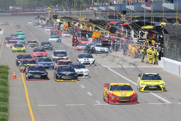 Joey Logano leads Matt Kenseth out of the pits during the NASCAR Sprint Cup series auto race at Michigan International Speedway, Sunday, Aug. 16, 2015, in Brooklyn, Mich. (AP Photo/Bob Brodbeck)