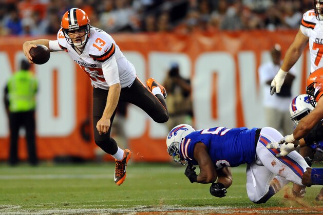 Aug 20, 2015; Cleveland, OH, USA; Cleveland Browns quarterback Josh McCown (13) jumps away from Buffalo Bills defensive end Jerry Hughes (55) during the first quarter at FirstEnergy Stadium. Mandatory Credit: Ken Blaze-USA TODAY Sports