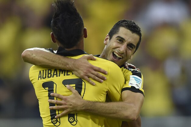 Dortmund's Henrikh Mkhitaryan, right, celebrates after scoring the third goal of the game assisted by teammate Pierre-Emerick Aubameyang, left, during the German Bundesliga soccer match between Borussia Dortmund and Borussia Moenchengladbach in Dortmund, Germany, Saturday, Aug. 15, 2015. (AP Photo/Martin Meissner)
