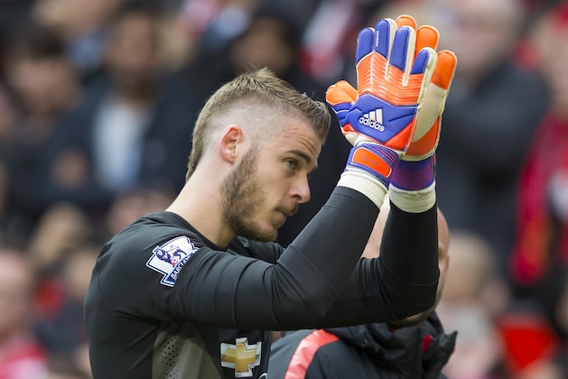 Manchester United's goalkeeper David De Gea applauds supporters as he makes his way from the pitch as he is substituted during the English Premier League soccer match between Manchester United and Arsenal at Old Trafford Stadium, Manchester, England, Sunday, May 17, 2015. (AP Photo/Jon Super)