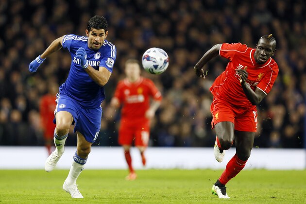 Liverpool's Mamadou Sakho, right, battles for the ball with Chelsea's Diego Costa during the English League Cup semifinal second leg soccer match between Chelsea and Liverpool at Stamford Bridge stadium in London, Tuesday, Jan. 27, 2015. (AP Photo/Kirsty Wigglesworth)