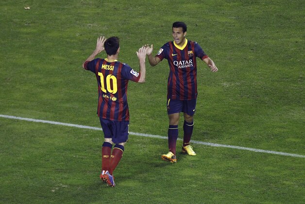 FC Barcelona's Pedro Rodriguez, right,  celebrates his goal with Lionel Messi from Argentina, left, during a Spanish La Liga soccer match against Rayo Vallecano at the Vallecas stadium in Madrid, Spain, Saturday, Sept. 21, 2013. (AP Photo/Andres Kudacki)