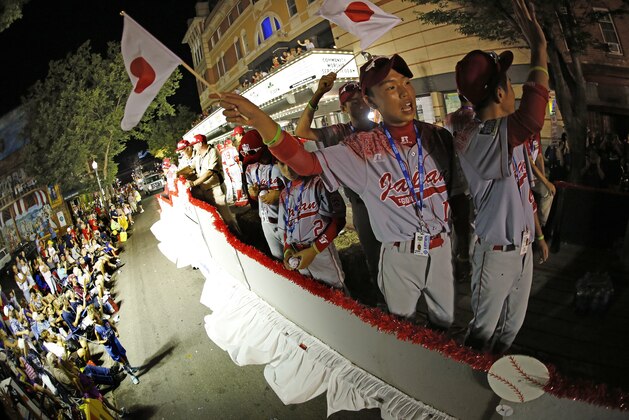 Members of the Little League team from Japan ride in the Little League Grand Slam Parade in downtown Williamsport, Pa., Wednesday, Aug. 19, 2015. The Little League World Series tournament gets started, Thursday, August 20, in South Williamsport, Pa.. AP Photo/Gene J. Puskar).