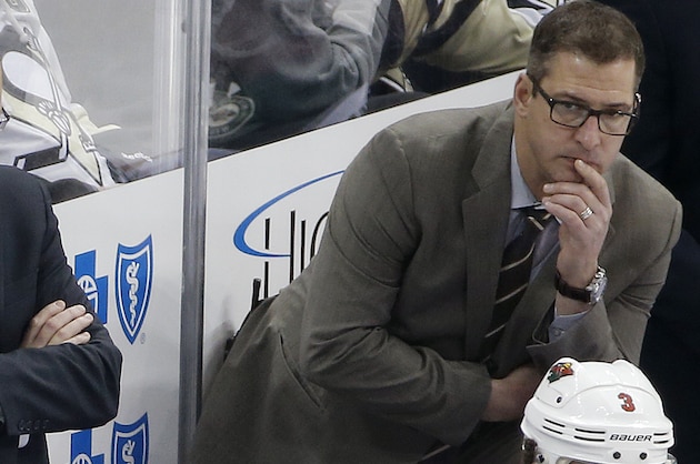 Minnesota Wild head coach Mike Yeo, center, is flanked by assistants Andrew Brunette, left, and Darryl Sydor, right, behind their bench during the third period of an NHL hockey game against the Pittsburgh Penguins in Pittsburgh Tuesday, Jan. 13, 2015. The Penguins won 7-2. (AP Photo/Gene J. Puskar)