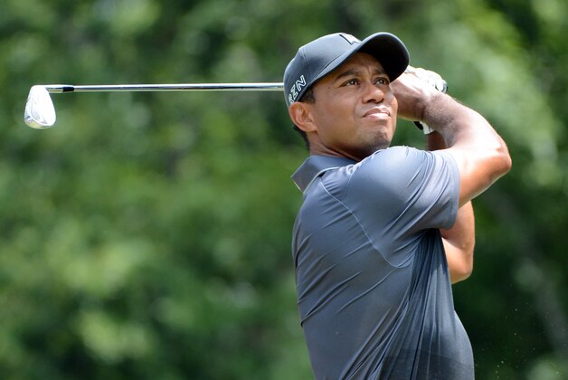 Aug 21, 2015; Greensboro, NC, USA; Tiger Woods watches his approach shot on the 1st hole during the second round of the Wyndham Championship golf tournament at Sedgefield Country Club. Mandatory Credit: Rob Kinnan-USA TODAY Sports