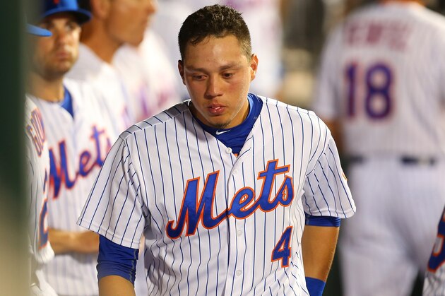 NEW YORK, NY - JULY 29:  Wilmer Flores #4 of the New York Mets looks on in the dugout in the ninth inning duirng the game against the San Diego Padres at Citi Field on July 29, 2015 in Flushing neighborhood of the Queens borough of New York City.  (Photo by Mike Stobe/Getty Images)