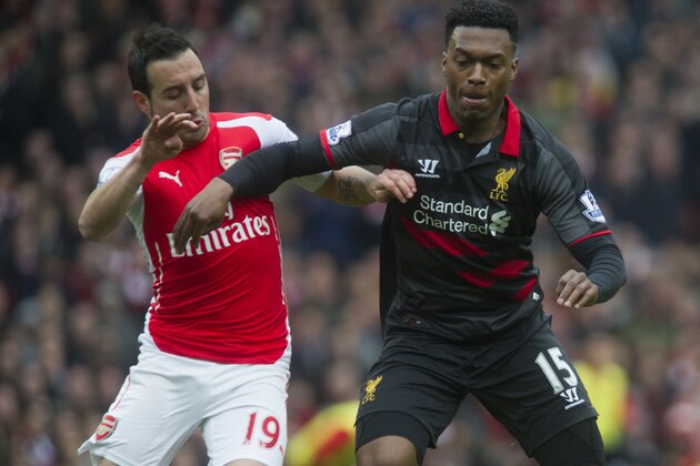 Arsenal's Santi Cazorla, fights for the ball with Liverpool's Daniel Sturridge, during their English Premier League soccer match, at Emirates Stadium, in London, Saturday, April 4, 2015. (AP Photo/Bogdan Maran)