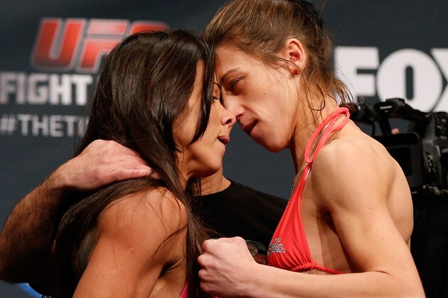 PHOENIX, AZ - DECEMBER 12:  (L-R) Opponents Claudia Gadelha of Brazil and Joanna Jedrzejczyk of Poland face off during the UFC Fight Night weigh-in event at the Phoenix Convention Center on December 12, 2014 in Phoenix, Arizona. (Photo by Josh Hedges/Zuffa LLC/Zuffa LLC via Getty Images)