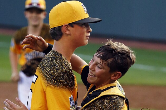 Taylors, South Carolina pitcher Alex Edmondson, left, celebrates with catcher Braden Golinski after getting the final out of the sixth inning of a baseball game in United States pool play against Cranston, Rhode Island at the Little League World Series tournament in South Williamsport, Pa., Friday, Aug. 21, 2015. South Carolina won, with Edmondson not allowing a hit, 7-1.  (AP Photo/Gene J. Puskar)