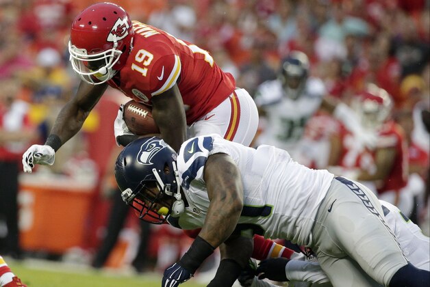 Kansas City Chiefs wide receiver Jeremy Maclin (19) is tackled by Seattle Seahawks outside linebacker Bruce Irvin (51) during the first half of an NFL football game at Arrowhead Stadium in Kansas City, Mo., Friday, Aug. 21, 2015. (AP Photo/Charlie Riedel)