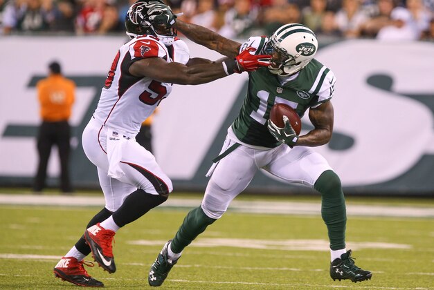 Aug 21, 2015; East Rutherford, NJ, USA; New York Jets wide receiver Brandon Marshall (15) runs with the ball while trying to avoid a tackle by Atlanta Falcons linebacker Allen Bradford (53) during the first half at MetLife Stadium. Mandatory Credit: Ed Mulholland-USA TODAY Sports
