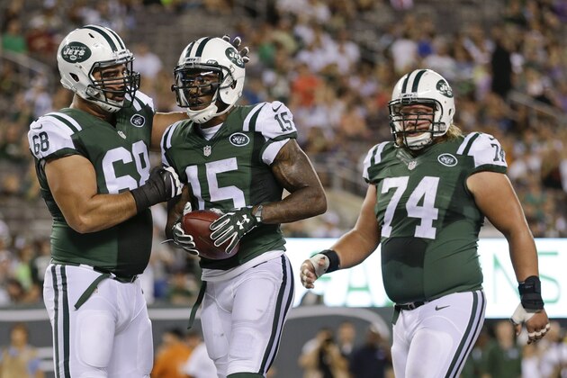 New York Jets' Breno Giacomini (68) and Nick Mangold (74) celebrate with Brandon Marshall (15) after Marshall's catch for a two point conversion during the first half of a preseason NFL football game against the Atlanta Falcons Friday, Aug. 21, 2015, in East Rutherford, N.J. (AP Photo/Adam Hunger)