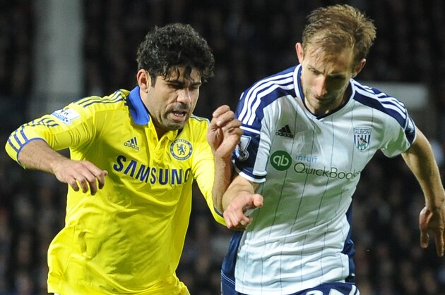 Chelsea's Diego Costa, left, contest the ball with West Brom's Craig Dawson during the English Premier League soccer match between West Bromwich Albion and Chelsea at the Hawthorns, West Bromwich, England, Monday, May 18, 2015. (AP Photo/Rui Vieira)