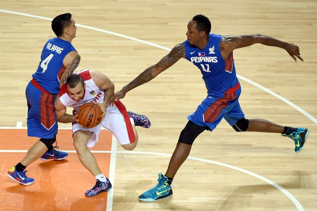 INCHEON, SOUTH KOREA - SEPTEMBER 25:  Mahdi Kamrani of Iran is challenged by June Mar Fajardo of the Philippines during the Basketball Mens Preliminary round match between Iran and the Philippines during day five of the 2014 Asian Games at Hwaseong Sports Complex Gymnasium on September 25, 2014 in Incheon, South Korea.  (Photo by Stanley Chou/Getty Images)