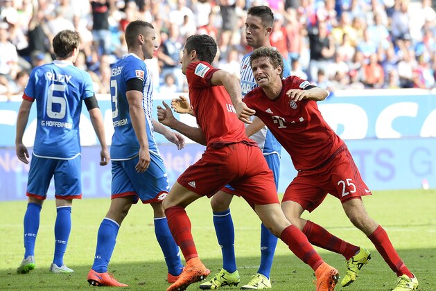 Bayern Munich's Polish forward Robert Lewandowski (C) celebrates with teammate forward Thomas Mueller (R) after he scored the winning goal during the German first division Bundesliga football match 1899 Hoffenheim vs FC Bayern Munich, on August 22, 2015 in Sinsheim, southwestern Germany. Bayern won 1-2.   AFP PHOTO / THOMAS KIENZLE 

RESTRICTIONS: DURING MATCH TIME: DFL RULES TO LIMIT THE ONLINE USAGE TO 15 PICTURES PER MATCH AND FORBID IMAGE SEQUENCES TO SIMULATE VIDEO. 
== RESTRICTED TO EDITORIAL USE == FOR FURTHER QUERIES PLEASE CONTACT DFL DIRECTLY AT + 49 69 650050.        (Photo credit should read THOMAS KIENZLE/AFP/Getty Images)