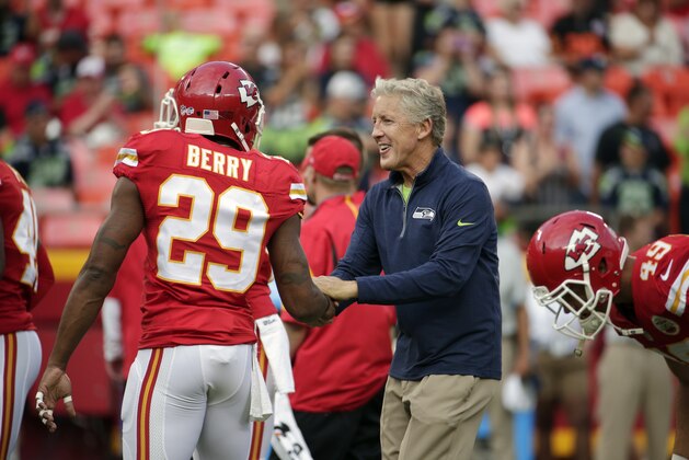 Seattle Seahawks head coach Pete Carroll greets Kansas City Chiefs strong safety Eric Berry (29) before an NFL football game at Arrowhead Stadium in Kansas City, Mo., Friday, Aug. 21, 2015. (AP Photo/Charlie Riedel)