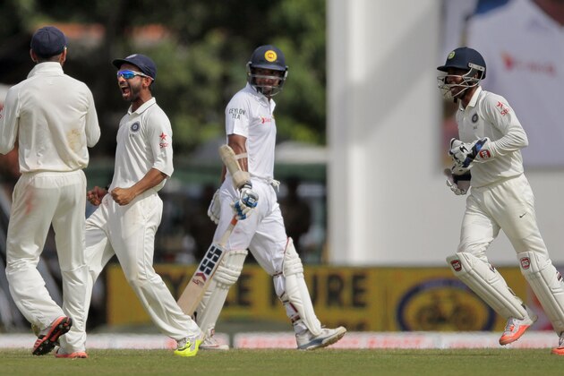 CORRECTS DATE - In this Friday, Aug. 21, 2015 photo, India's Ajinkya Rahane, second left, Virat Kohli, left, and Wriddhiman Saha, right, celebrate the dismissal of Sri Lanka's Kumar Sangakkara during the third day's play of the second test cricket match between them in Colombo, Sri Lanka. (AP Photo/Eranga Jayawardena)