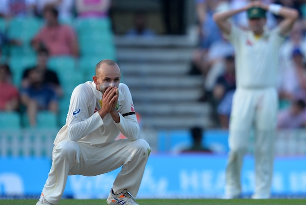 Australia's Nathan Lyon (L) reacts during play on the third day of the fifth Ashes cricket test match between England and Australia at The Oval cricket ground in London, on August 22, 2015. AFP PHOTO / GLYN KIRK

RESTRICTED TO EDITORIAL USE. NO ASSOCIATION WITH DIRECT COMPETITOR OF SPONSOR, PARTNER, OR SUPPLIER OF THE ECB        (Photo credit should read GLYN KIRK/AFP/Getty Images)
