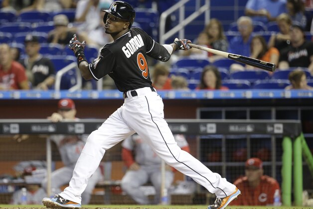 Miami Marlins second baseman Dee Gordon follows through on a single in the seventh inning of a baseball game against the Cincinnati Reds, Saturday, July 11, 2015, in Miami. The Marlins defeated the Reds 14-3. (AP Photo/Lynne Sladky)