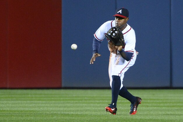 Atlanta Braves center fielder Eric Young Jr. fields a single by on a fly ball by Washington Nationals' Danny Espinosa during the seventh inning of a baseball game Wednesday, April 29, 2015, in Atlanta. (AP Photo/David Tulis)