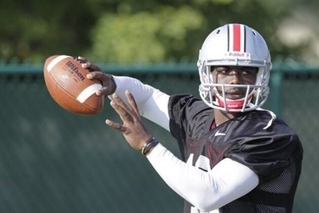 FILE - In this Aug. 9, 2014, file photo, Ohio State quarterback J.T. Barrett throws a pass during NCAA college football practice in Columbus, Ohio. His teammates and coaches say Barrett has taken over as No. 5 Ohio State's starting quarterback as if that were the plan all along. It wasn't, of course. Barrett, a freshman, got the job when two-time Big Ten player of the year Braxton Miller reinjured his throwing shoulder 10 days ago and was lost for the season. (AP Photo/Jay LaPrete, File)