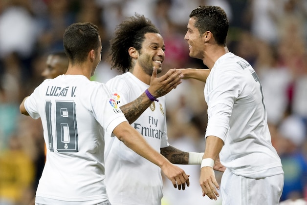 Real Madrid's Brazilian defender Marcelo (C) celebrates a goal with teammate Real Madrid's Portuguese forward Cristiano Ronaldo (R) during the Trofeo Santiago Bernabeu football match Real Madrid vs Galatasaray at the Santiago Bernabeu stadium in Madrid on August 18, 2015.  AFP PHOTO / DANI POZO        (Photo credit should read DANI POZO/AFP/Getty Images)