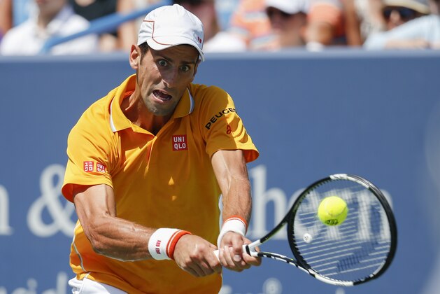 Novak Djokovic, of Serbia, returns the ball to to Alexandr Dolgopolov, from Ukraine, during the semifinals at the Western & Southern Open tennis tournament, Saturday, Aug. 22, 2015, in Mason, Ohio. Djokovic won 4-6, 7-6 (5), 6-2. (AP Photo/John Minchillo)