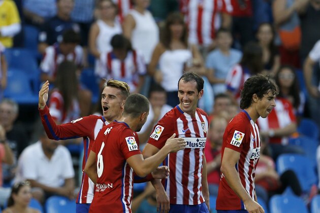Atletico Madrid's Antoine Griezmann, left, celebrates with teammates after scoring the opening goal against Las Palmas during the Spanish La Liga soccer match between Atletico Madrid and Las Palmas at the Vicente Calderon stadium in Madrid, Spain, Saturday, Aug. 22, 2015. (AP Photo/Francisco Seco)