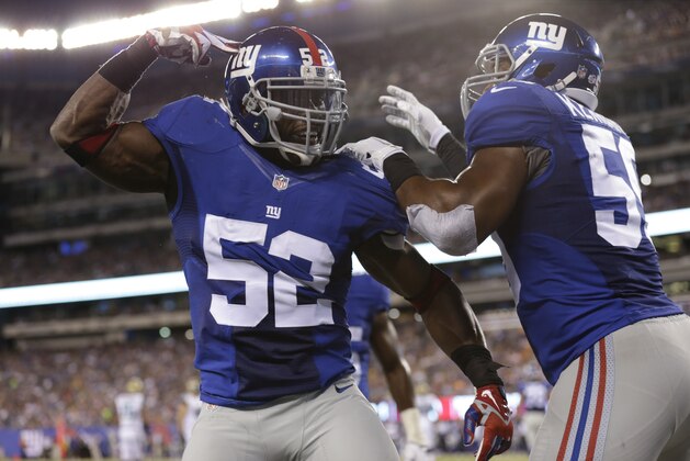 New York Giants middle linebacker Jon Beason (52) celebrate with teammate Devon Kennard (59) after breaking up a pass to Jacksonville Jaguars' Denard Robinson during the first half of a preseason NFL football game Saturday, Aug. 22, 2015, in East Rutherford, N.J. (AP Photo/Adam Hunger)