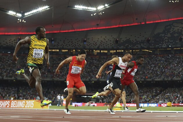 Jamaica's Usain Bolt, left, competes in a men’s 100m semifinal at the World Athletics Championships at the Bird's Nest stadium in Beijing, Sunday, Aug. 23, 2015. (AP Photo/David J. Phillip)