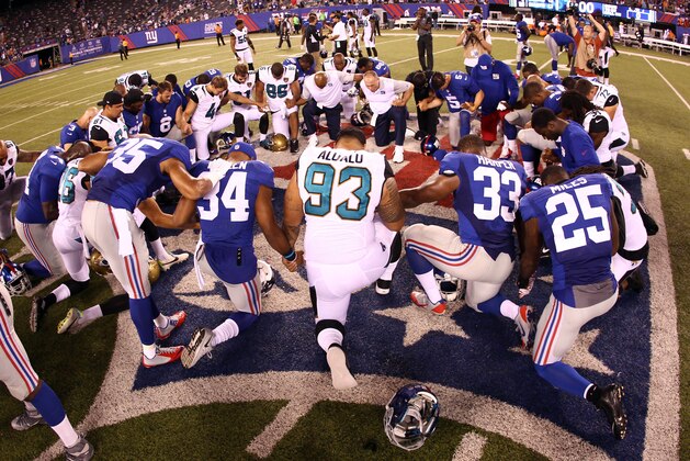 Aug 22, 2015; East Rutherford, NJ, USA; Players from the New York Giants and Jacksonville Jaguars pray after the Giants beat the Jaguars 22-12 at MetLife Stadium. Mandatory Credit: Danny Wild-USA TODAY Sports