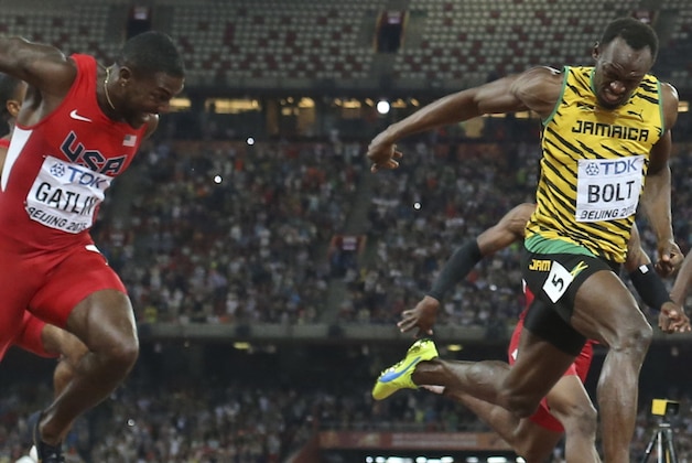 Jamaica's Usain Bolt crosses the finish line to win the men’s 100m final at the World Athletics Championships at the Bird's Nest stadium in Beijing, Sunday, Aug. 23, 2015. United States' Justin Gatlin, left, was second. (AP Photo/David J. Phillip)