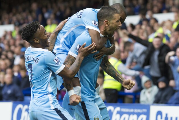 Manchester City's Aleksandar Kolarov, center, celebrates with teammates after scoring during the English Premier League soccer match between Everton and Manchester City at Goodison Park Stadium, Liverpool, England, Sunday Aug. 23, 2015. (AP Photo/Jon Super)