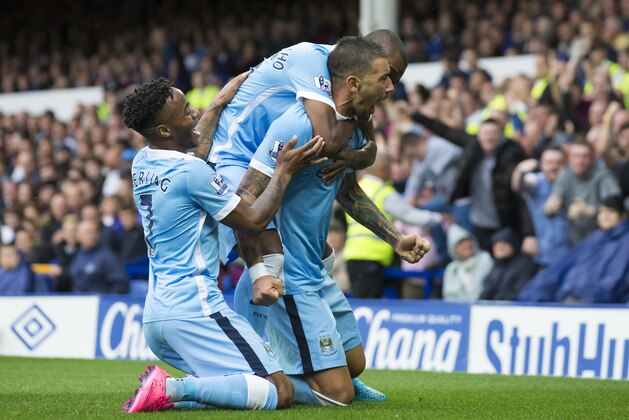 Manchester City's Aleksandar Kolarov, center, celebrates with teammates after scoring during the English Premier League soccer match between Everton and Manchester City at Goodison Park Stadium, Liverpool, England, Sunday Aug. 23, 2015. (AP Photo/Jon Super)
