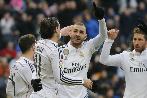 Real Madrid's Karim Benzema, center, celebrates after he scored during a Spanish La Liga soccer match between Real Madrid and Real Sociedad at the Santiago Bernabeu stadium in Madrid, Spain, Saturday Jan. 31, 2015. (AP Photo/Paul White)