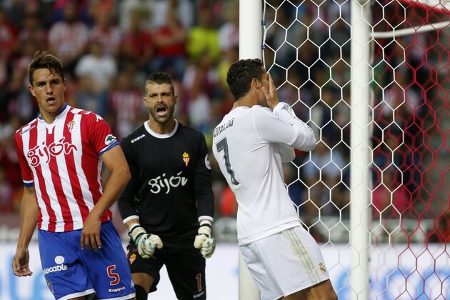 Real Madrid's Cristiano Ronaldo, right, reacts during a Spanish La Liga soccer match between Real Madrid and Sporting de Gijon at the 'El Molinon' stadium in Gijon, Spain, Sunday, Aug. 23, 2015. (AP Photo/Jose Vicente)